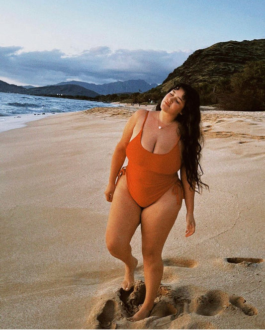 Model wearing cheeky one piece swimsuit in a sleek, minimal design – stylish one piece swimwear for confident beachwear.